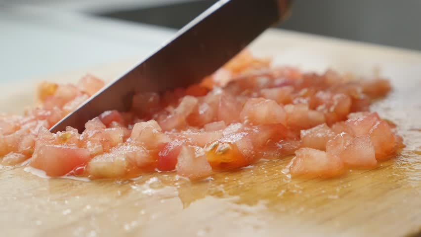 cutting-tomatoes-on-smaller-pieces-and-arranging-with-knife-close-up-4k