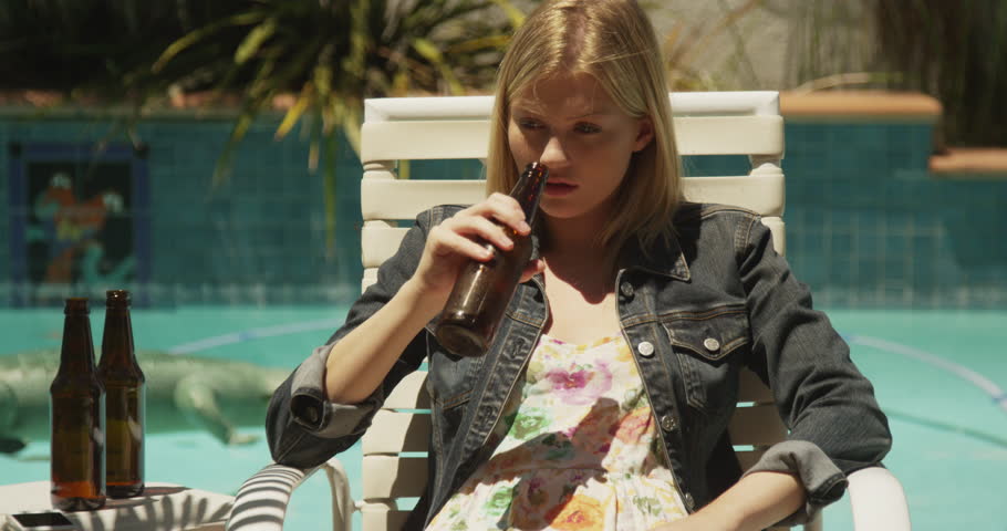 Woman Drinking Beer In Swimming Pool, Steadycam Shot, Slow Motion Shot