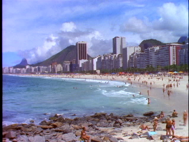 Sunbathers Lie In The Sand Of Copacabana Beach In Rio De Janeiro