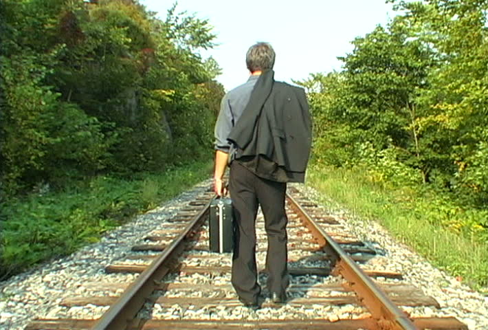 Video Of A Business Man Walking Away On An Empty Railroad Track