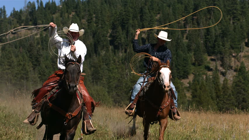 Two Cowboys Riding Horseback Swinging Lassos, Slow Moiton &hellip;