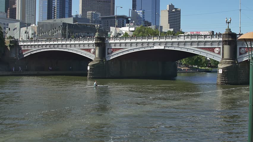 MELBOURNE, AUSTRALIA - MARCH 21, 2015: Rower in a canoe rowing next to 