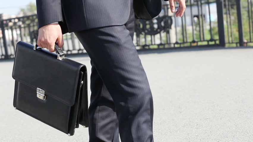 Close-up Of A Business Guy Carrying A Leather Briefcase Somewhere In ...