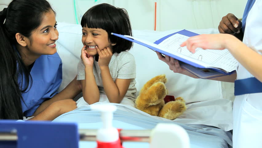 Portrait Of A Pediatric Nurse With Medical Records With A South Asian ...