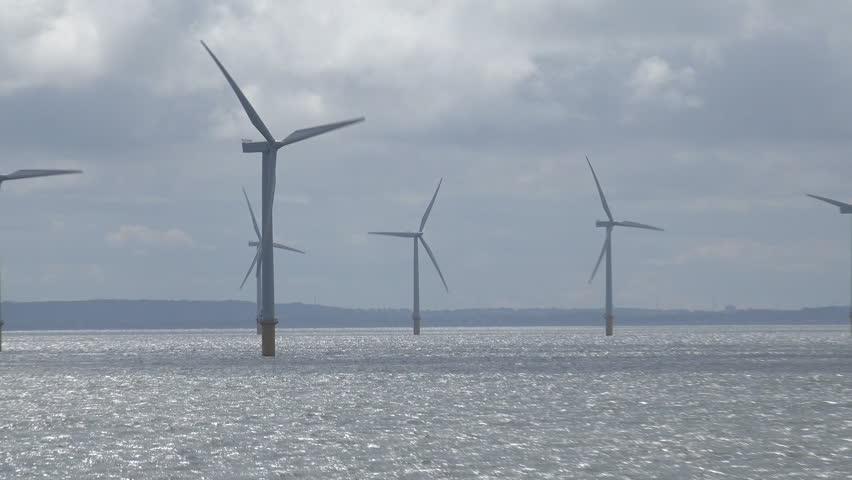 Tracking Shot Of Wind Farm Turbines In Irish Sea In Liverpool Bay ...