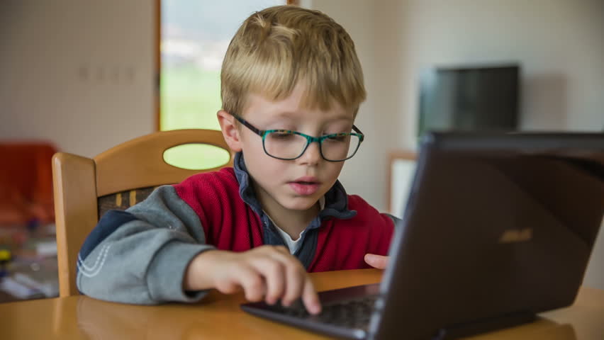 Enthusiastic Kid On Laptop Computer. Sliding Over Computer Screen With ...