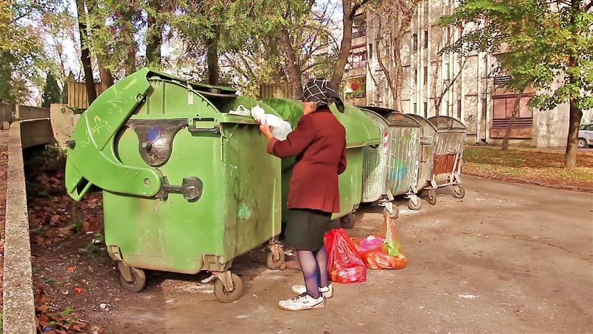 Homeless Woman Is Searching For Food In Garbage Dumpster/Woman In ...