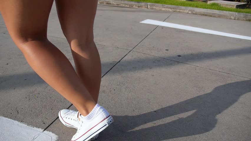 Close Up Of Young Woman Legs In Converse Walking On Street. HD ...